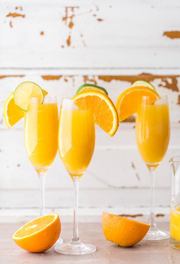 Moscow Mule Mimosas make for the BEST BRUNCH EVER! So easy, unique, delicious, and fun! Spiked ginger beer, orange juice, and champagne! YUM!