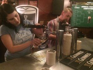 Bartenders Bonnie Westerfield and Tony Argento battle to pour the perfect pint, photo by Sara Havens