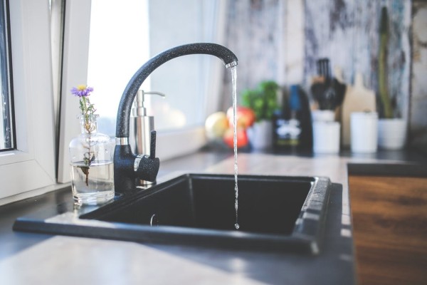 Water flows from the tap to sink