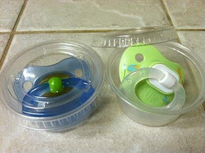 Keep pacifiers clean in your bag with sauce-to-go containers.