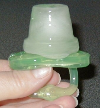 Freeze a pacifier in an ice cube tray with juice, milk, formula, or water to sooth a teething baby’s gums.