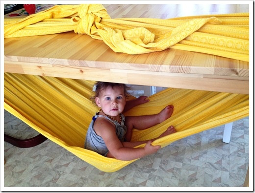 Make a hammock with a blanket tied around a table
